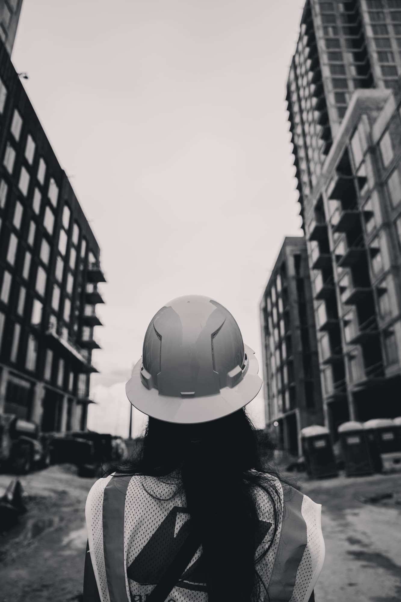 An AXIS crew member looking up at a Miami high-rise under construction