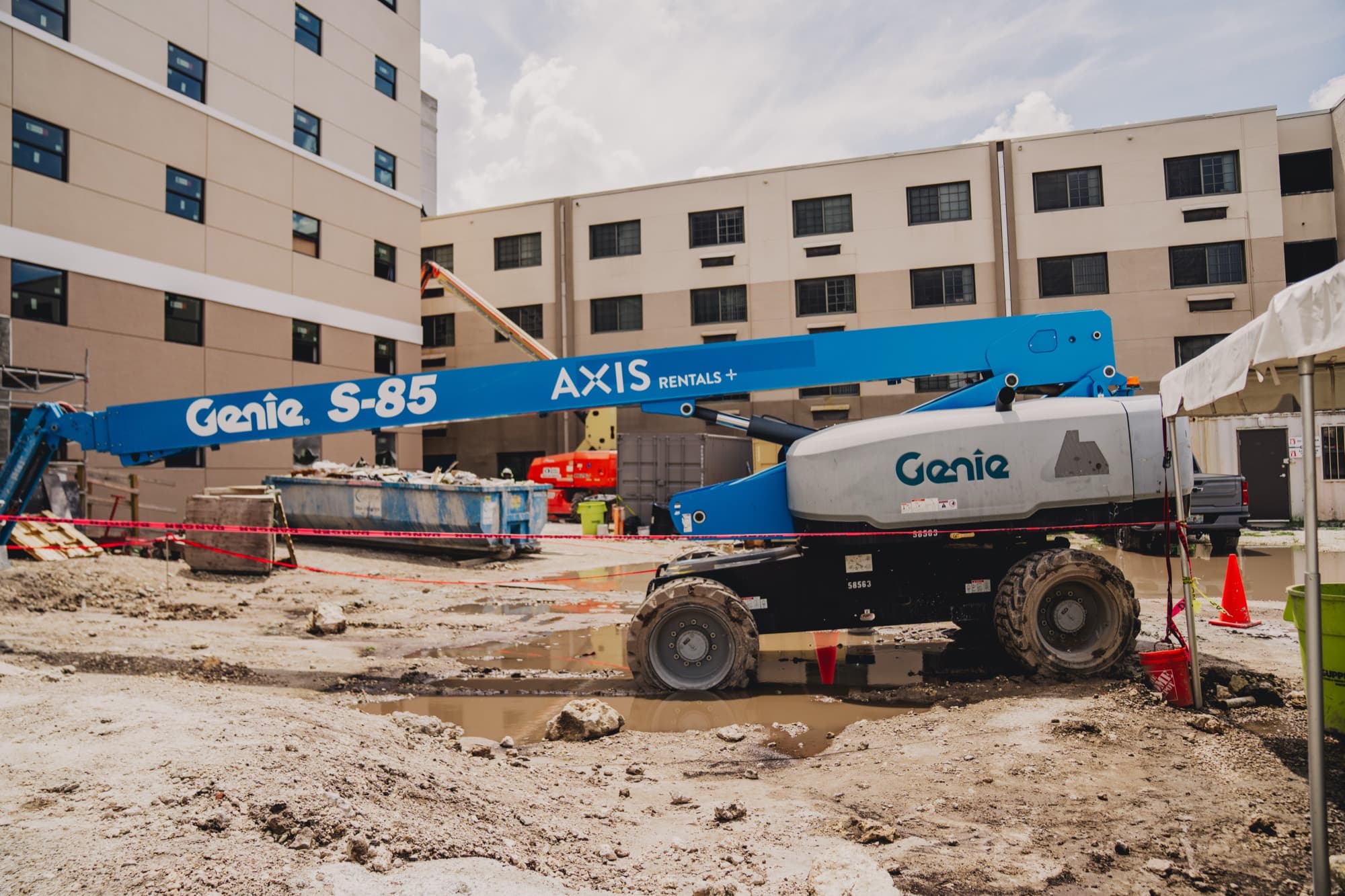 An AXIS Rentals boom lift on an active Miami construction site