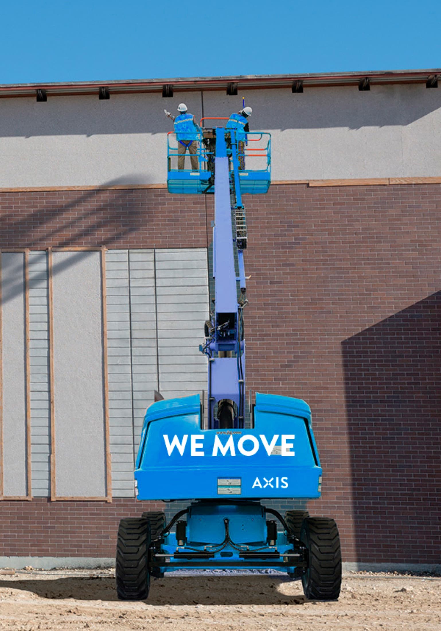 An AXIS boom lift with crew performing façade work on a building